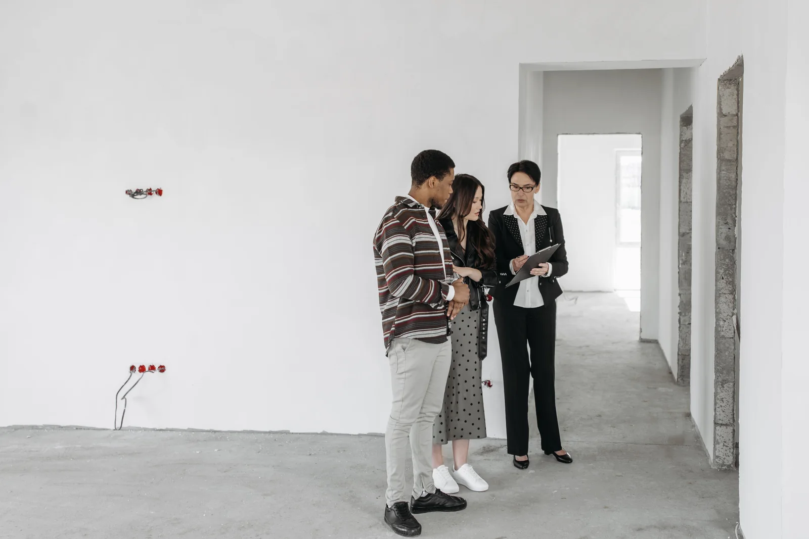 Real estate investors reviewing a property with a professional